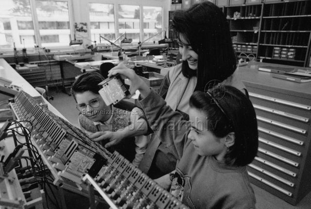 Kinder besuchen ihre Eltern am Arbeitsplatz - Zwei Kinder und die Mutter an deren Arbeitsplatz; um 1995