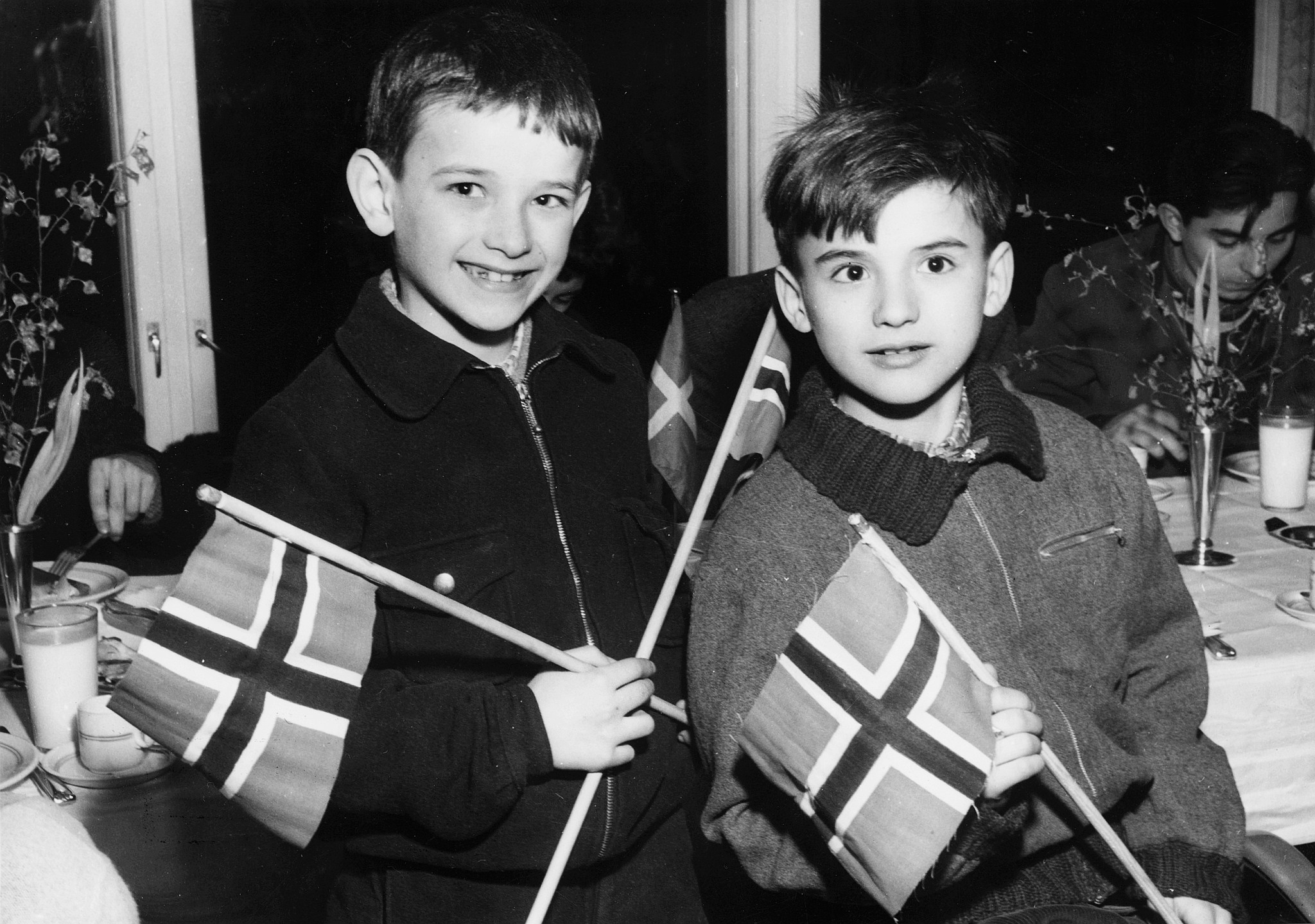 Norwegische Europahilfe: Frohe und nette ungarische Flüchtlingskinder beim Empfang in Norwegen mit Fahnen
