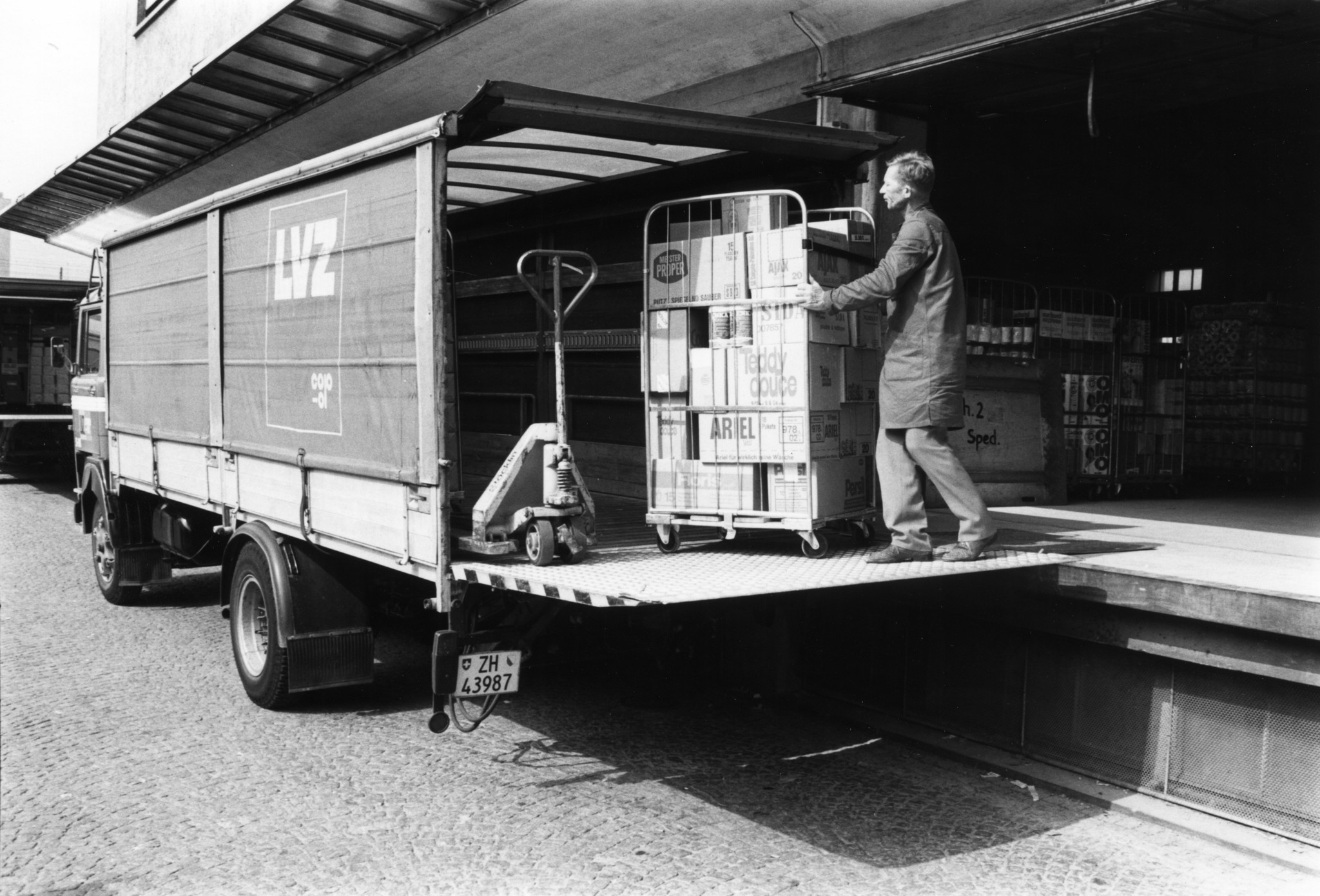 Mann beim Verladen von Waschmitteln in einen Lieferwagen des Lebensmittelvereins Zürich