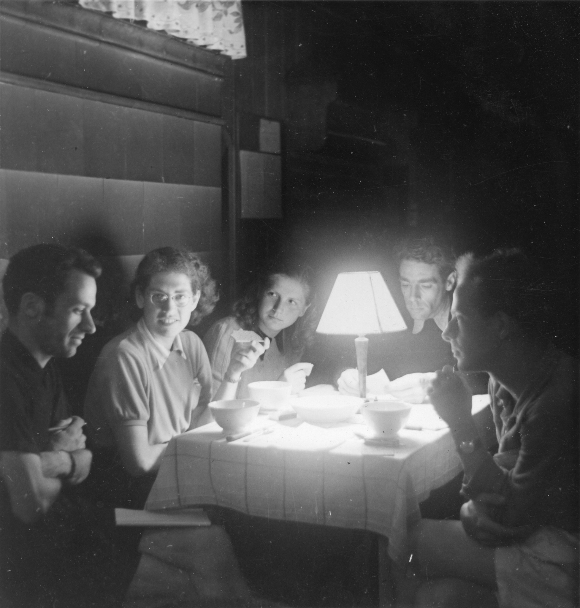 Jugendliche essen im Schein einer kleinen Lampe