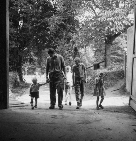 PraktikantInnenhilfe - Praktikant kommt mit den Kindern von der Arbeit; um 1965