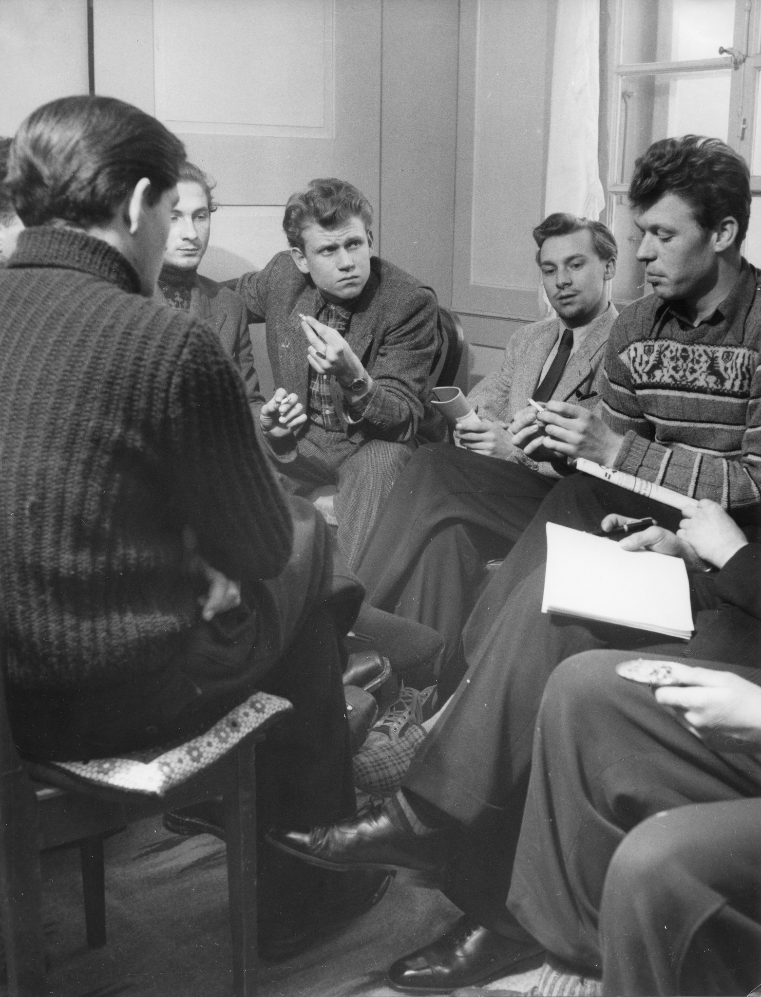 Erholungsaktion für jugendliche deutsche Flüchtlinge im Ferienhaus Lindenbühl 1952/1953; Jugendliche rauchend und diskutierend beieinander sitzend