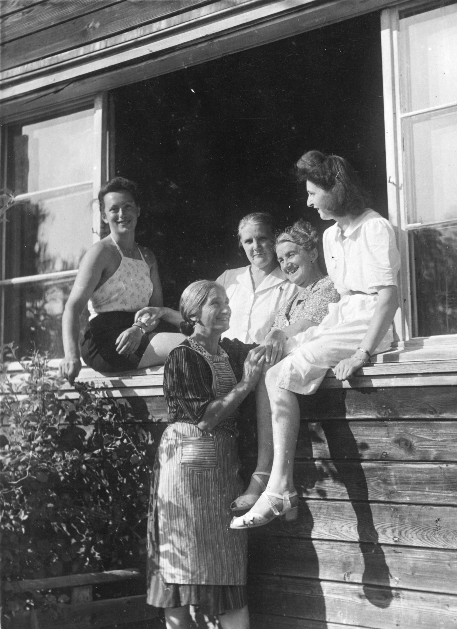 Betreuerinnen sitzen und stehen am Fenster