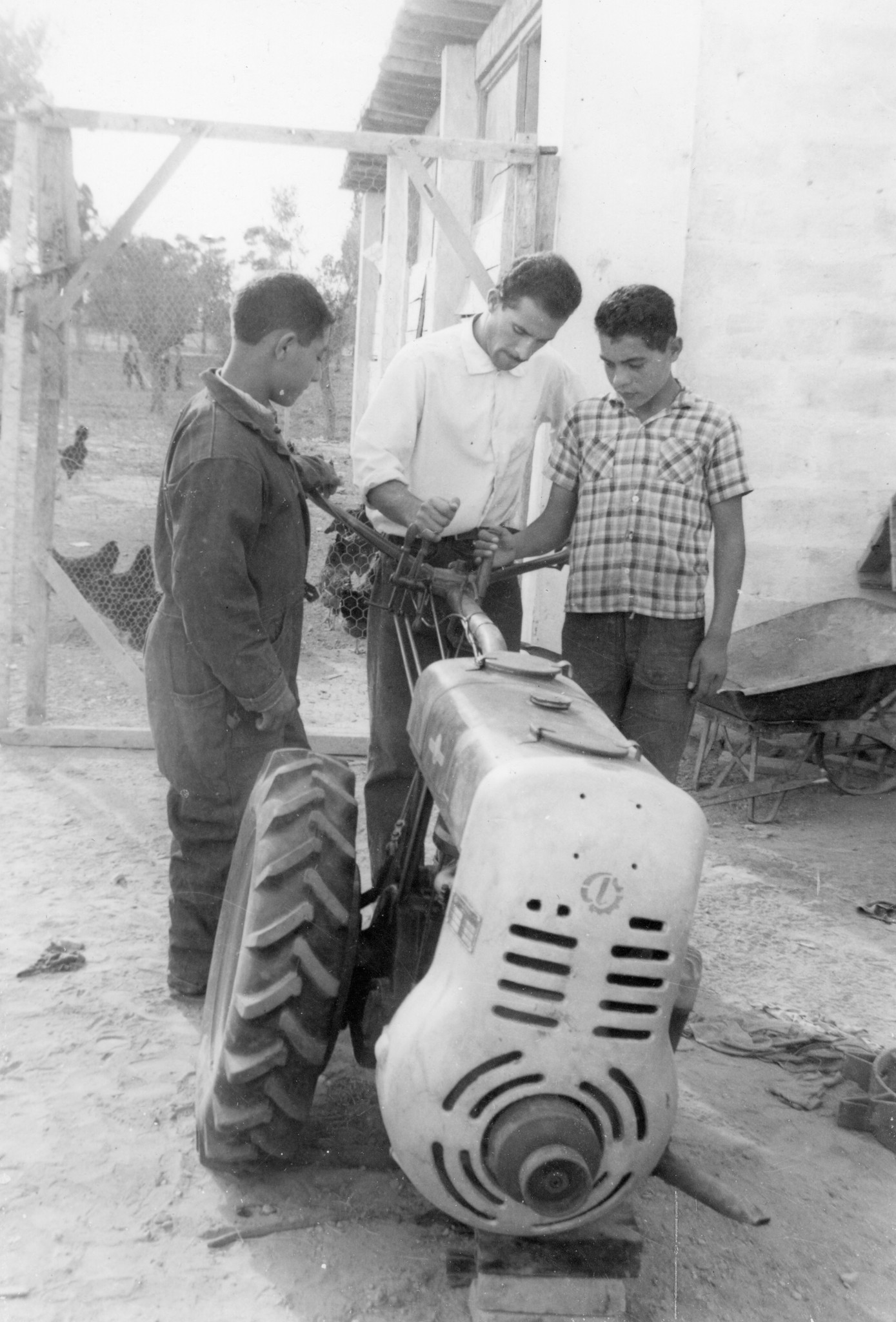 "Séction Agriculture"; drei junge Männer mit Motorpflug