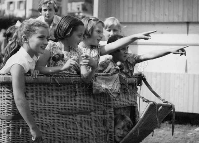 Kinder beim Spielen in einem Korb; um 1965